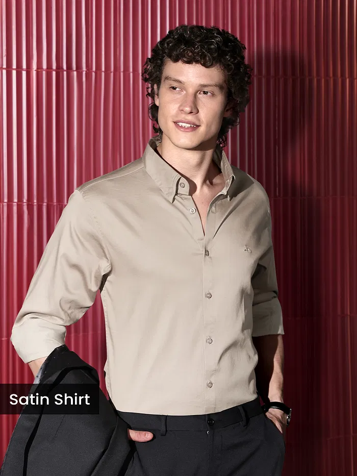 Man Wearing a clay beige "satin shirt for men" against a red background.